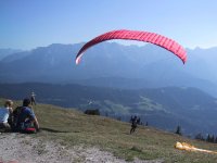 They pull the parasail toward them so it lifts just off the ground. Then they run off the side of the mountain. ;-)