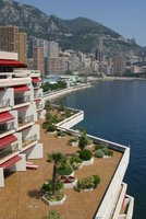 A view of Monaco and the beach from the hotel's restaurant.  The red awnings and grounds on the left are our hotel.