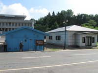 These rooms sit between the main NK building (in the background) and the main SK building (on whose steps I was standing).  The blue buildings you see belong to the US/South Korea, and the gray ones belong to the North.