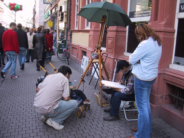 A portrait/charicature artist.  He's there every Saturday.